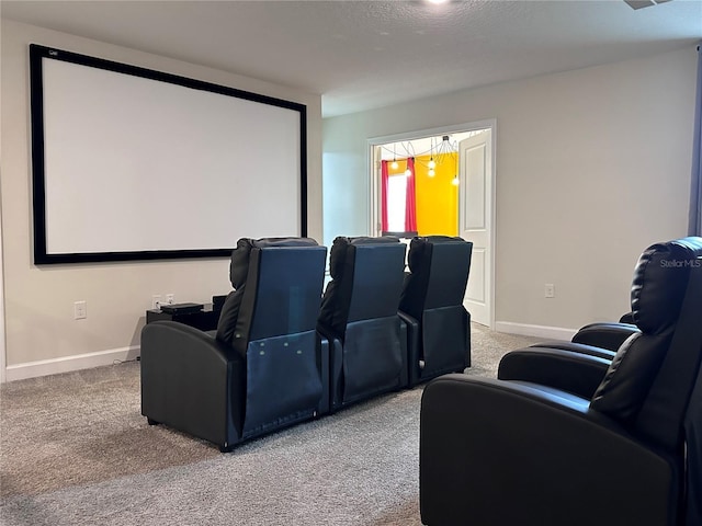 carpeted home theater room with baseboards