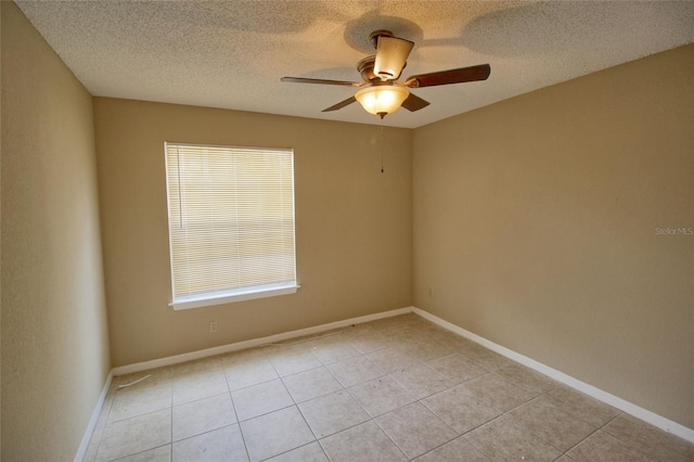 unfurnished room with baseboards, ceiling fan, and a textured ceiling