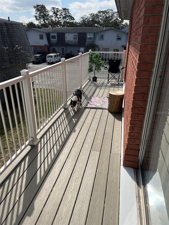 wooden terrace featuring a residential view