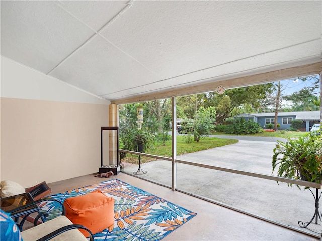 sunroom / solarium featuring vaulted ceiling