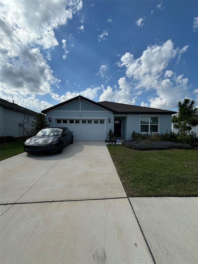 ranch-style home with a garage and a front lawn