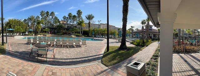 view of home's community featuring a pool, a patio area, and fence