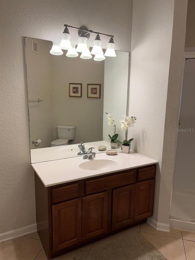 full bathroom with visible vents, toilet, a shower stall, vanity, and tile patterned flooring