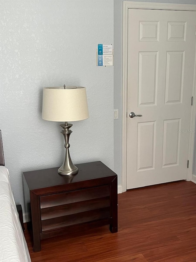 interior space with baseboards and dark wood-type flooring