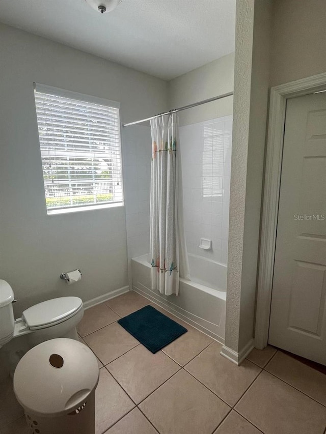 full bathroom featuring baseboards, tile patterned flooring, and shower / tub combo with curtain