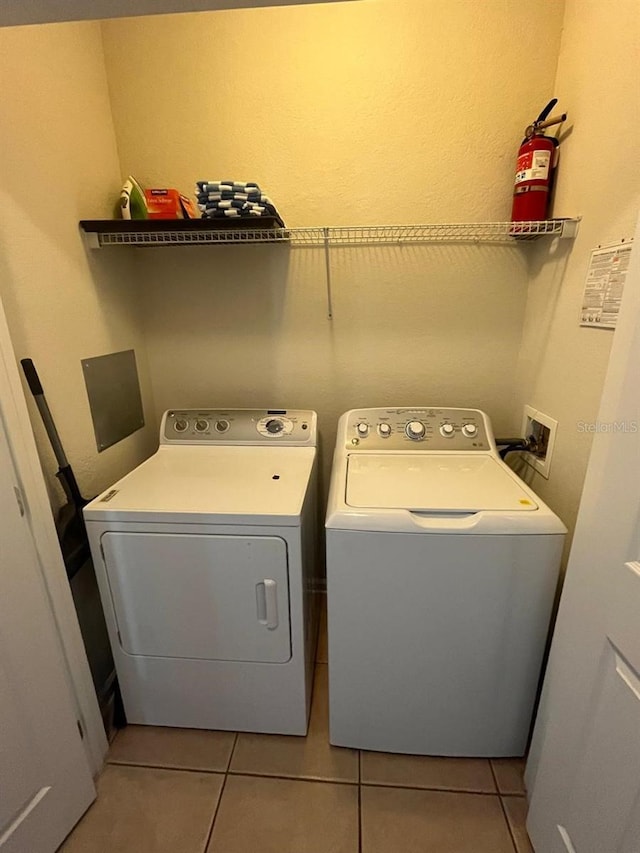 washroom with laundry area, independent washer and dryer, and light tile patterned floors