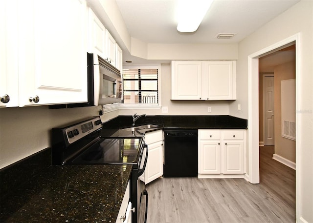 kitchen featuring black dishwasher, stainless steel microwave, electric range oven, and white cabinets