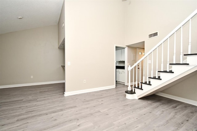 interior space featuring wood finished floors, visible vents, and baseboards