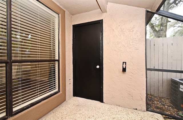 entrance to property featuring stucco siding