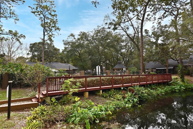 wooden terrace featuring a water view and a gazebo