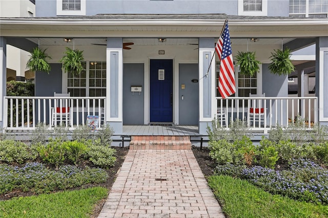 property entrance with a porch and stucco siding