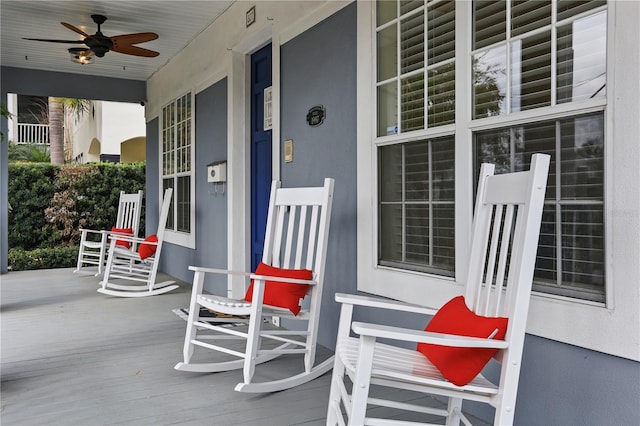 wooden terrace featuring ceiling fan and a porch