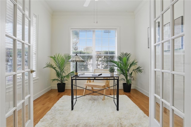 office with wood finished floors, a ceiling fan, baseboards, french doors, and crown molding