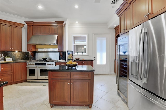 kitchen with light tile patterned flooring, stainless steel appliances, ornamental molding, ventilation hood, and tasteful backsplash