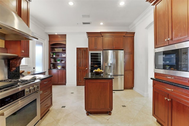 kitchen featuring ornamental molding, appliances with stainless steel finishes, ventilation hood, and a kitchen island