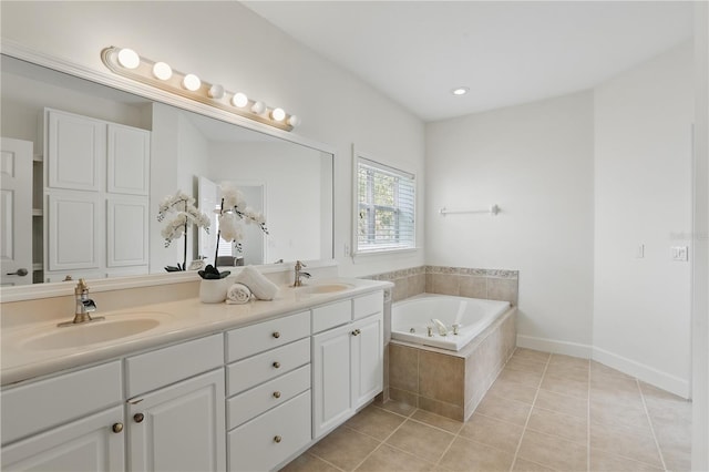 bathroom with tile patterned flooring, a sink, a bath, and double vanity