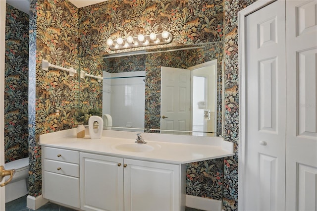 bathroom featuring toilet, wallpapered walls, a closet, and vanity