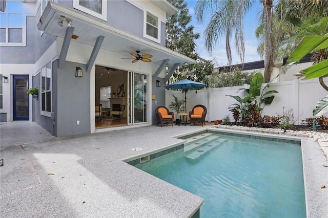 view of swimming pool with a patio area, a fenced backyard, a ceiling fan, and a fenced in pool