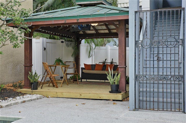 view of patio / terrace with fence, a deck, and a gazebo