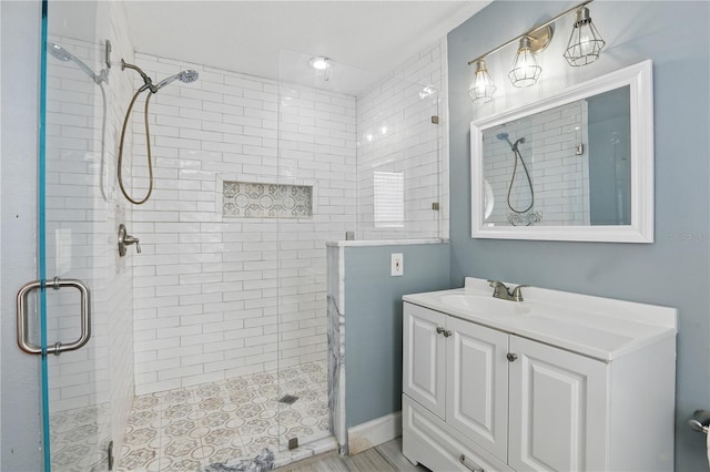 full bath with a stall shower and vanity