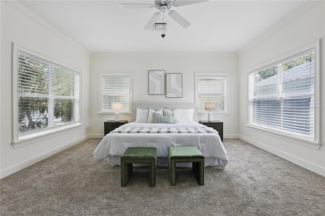 carpeted bedroom featuring ceiling fan, ornamental molding, visible vents, and baseboards