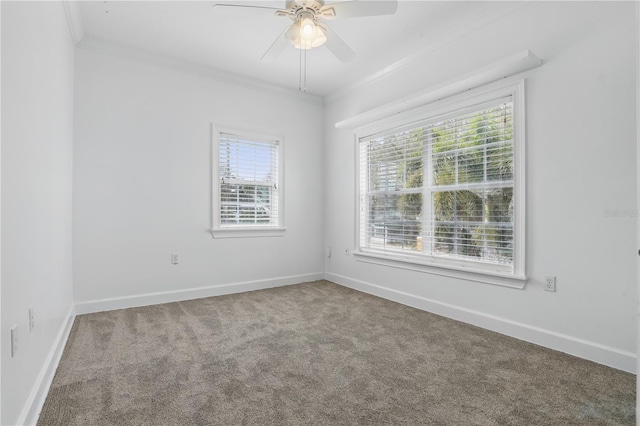 carpeted empty room featuring ornamental molding, a ceiling fan, and baseboards