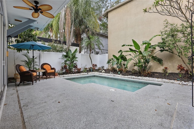 view of pool with a patio, a fenced backyard, a fenced in pool, and a ceiling fan