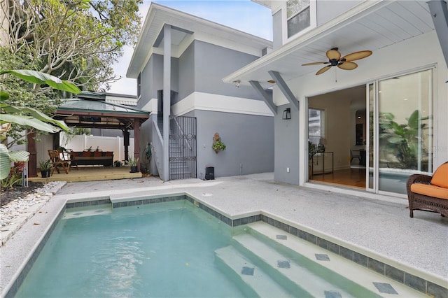 view of swimming pool with ceiling fan, a gazebo, a patio, and a fenced in pool