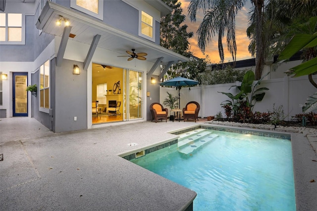 view of pool with a fenced in pool, a fenced backyard, ceiling fan, and a patio