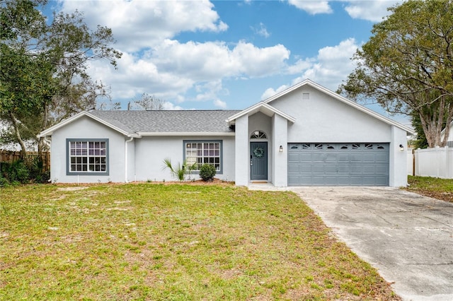 ranch-style home with concrete driveway, an attached garage, fence, a front yard, and stucco siding