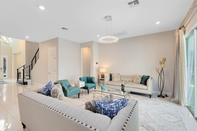 living area featuring stairway, recessed lighting, visible vents, and a notable chandelier