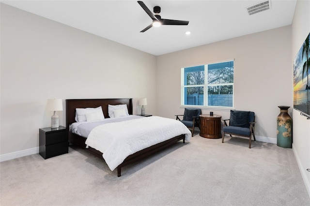 bedroom featuring baseboards, ceiling fan, visible vents, and light colored carpet