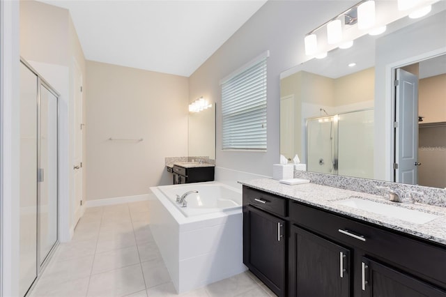 full bath with a garden tub, tile patterned flooring, two vanities, a sink, and a shower stall