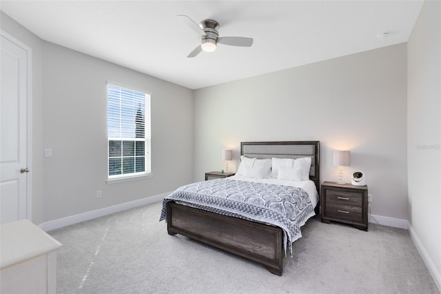 bedroom with light carpet, baseboards, and a ceiling fan