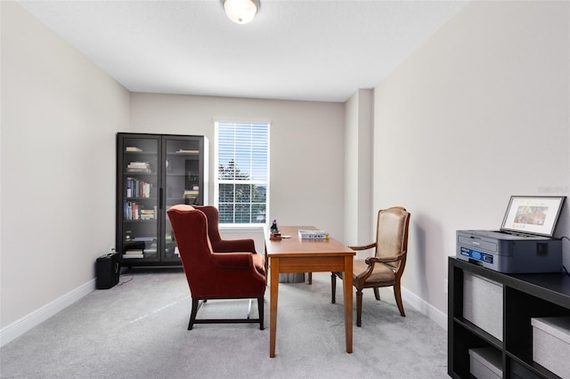 office featuring baseboards and light colored carpet