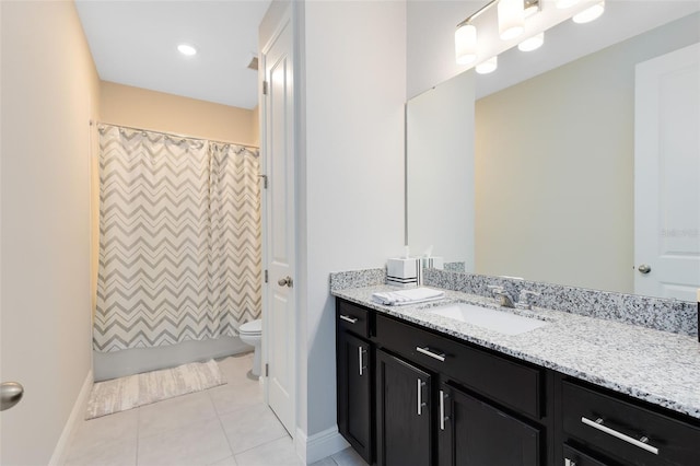 bathroom with toilet, tile patterned floors, baseboards, and vanity