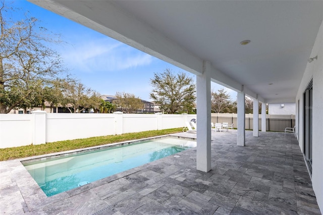 view of pool featuring a fenced in pool, a fenced backyard, and a patio