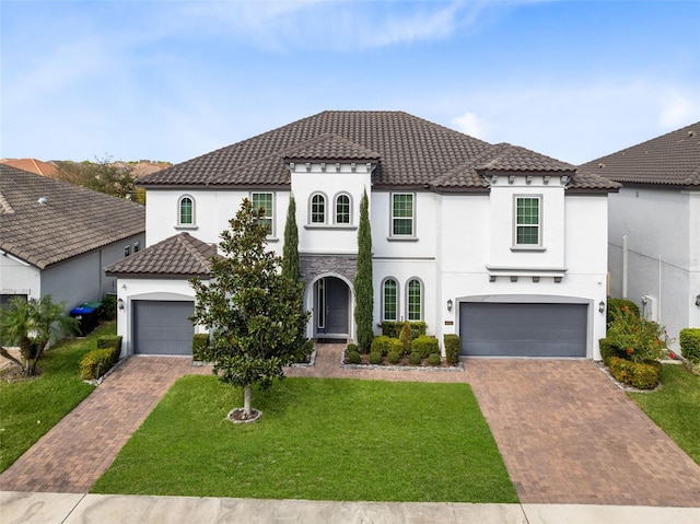 8390 Ludington Cir, Orlando, FL 32836 - mediterranean / spanish house featuring decorative driveway, a tiled roof, and a front yard