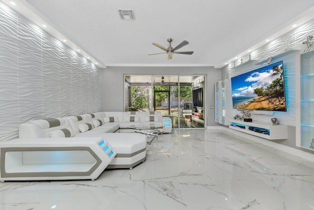 living room with ornamental molding, marble finish floor, visible vents, and ceiling fan