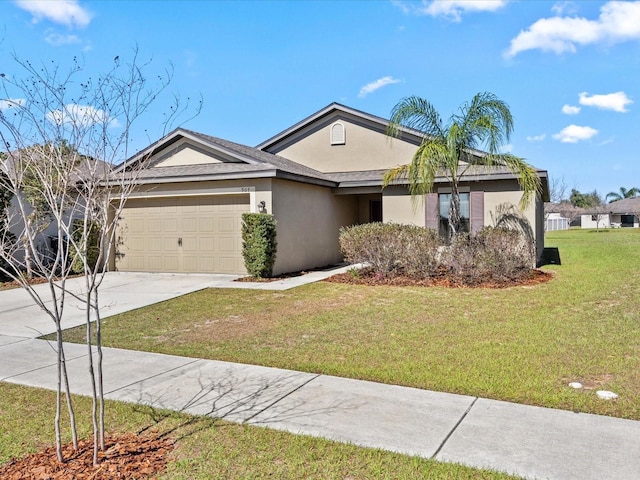 ranch-style house with a garage, a front yard, concrete driveway, and stucco siding