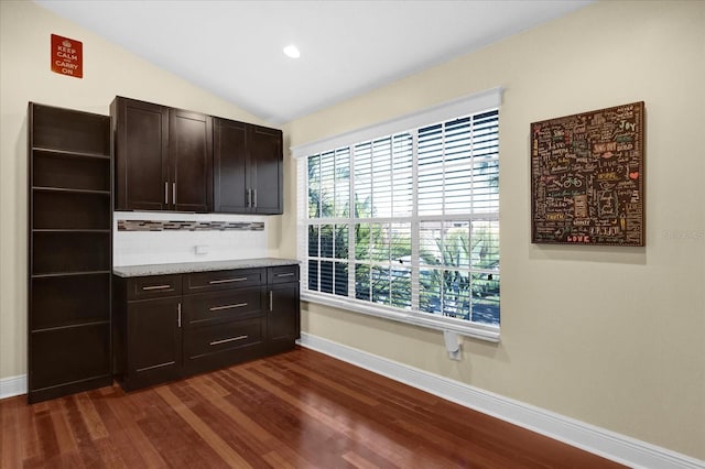 kitchen with lofted ceiling, dark brown cabinetry, dark wood-style floors, and open shelves