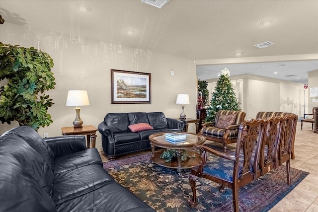 living room with light tile patterned flooring, visible vents, and recessed lighting