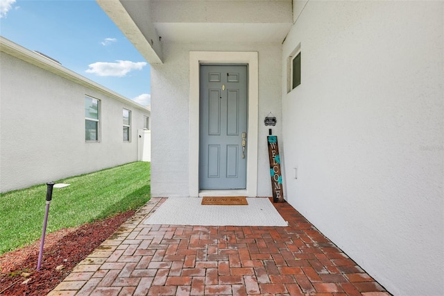 doorway to property with stucco siding