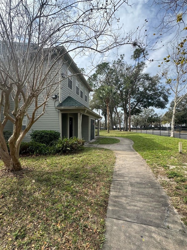 exterior space featuring fence and a lawn