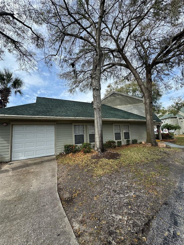 view of front facade with concrete driveway and an attached garage