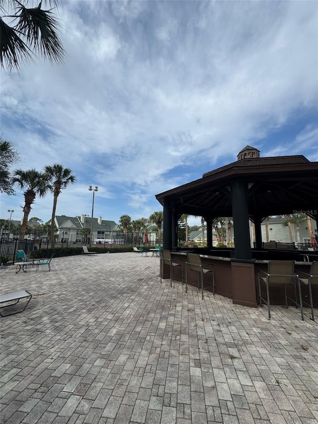 view of patio featuring fence and a gazebo