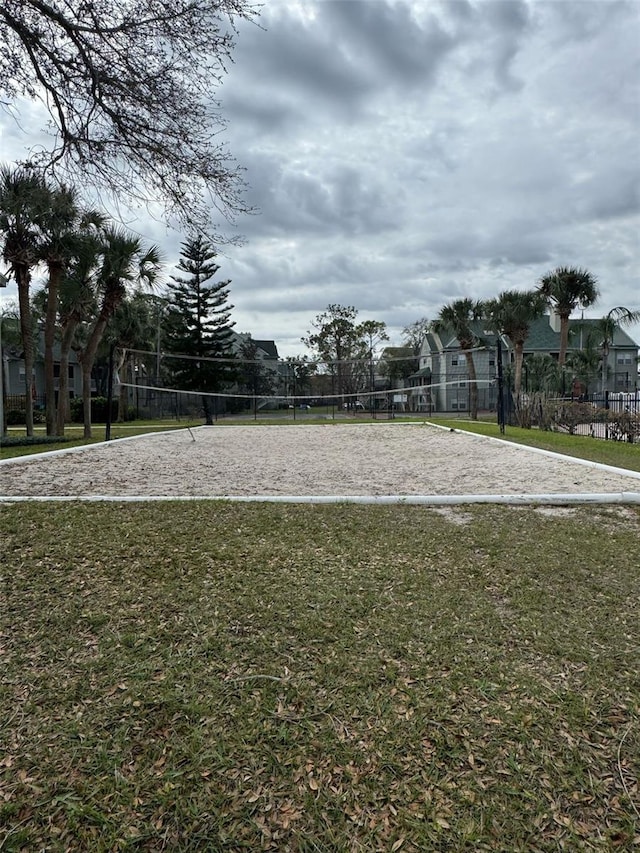 surrounding community featuring a yard, a residential view, fence, and volleyball court