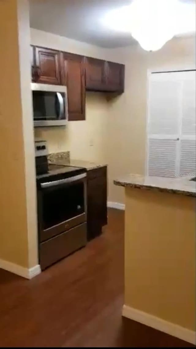 kitchen featuring baseboards and stainless steel appliances