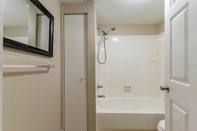 bathroom featuring toilet and bathing tub / shower combination