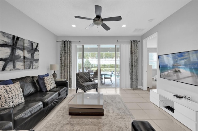 living room with light tile patterned floors, ceiling fan, visible vents, and recessed lighting